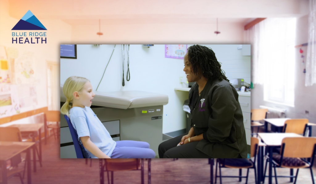 Child talking with a healthcare provider in a school-based health clinic, with a classroom visible in the background.