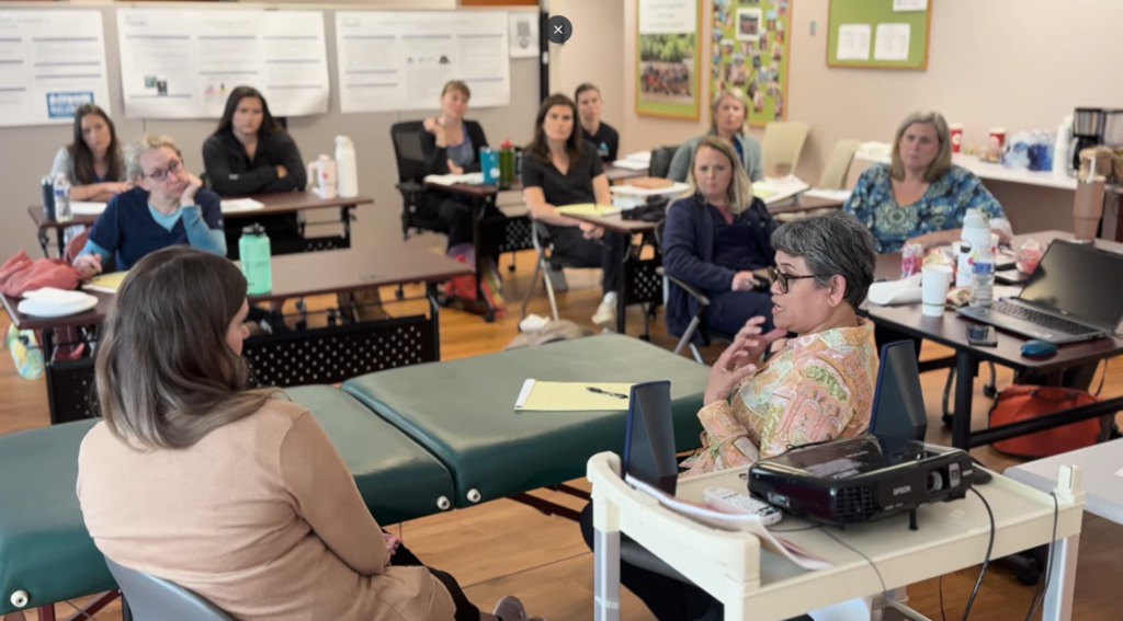 A group of medical professionals learning in a classroom